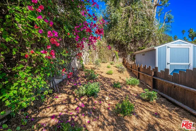 a view of a house with a backyard and a garage