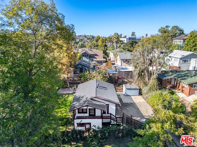 an aerial view of multiple houses with a yard