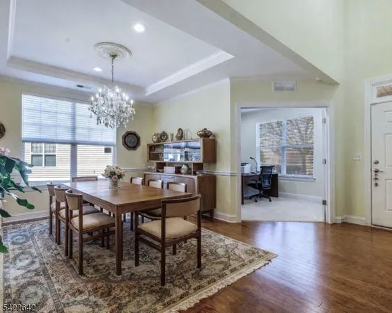 a view of a dining room with furniture wooden floor and chandelier