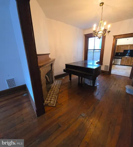a view of a livingroom with wooden floor and furniture