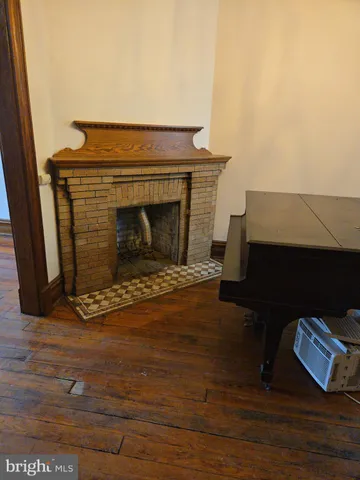 a view of living room with furniture and a fireplace