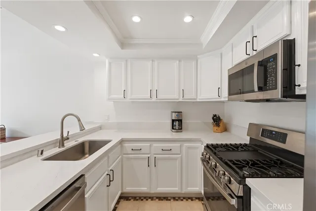 a kitchen with a sink stove top oven and cabinets
