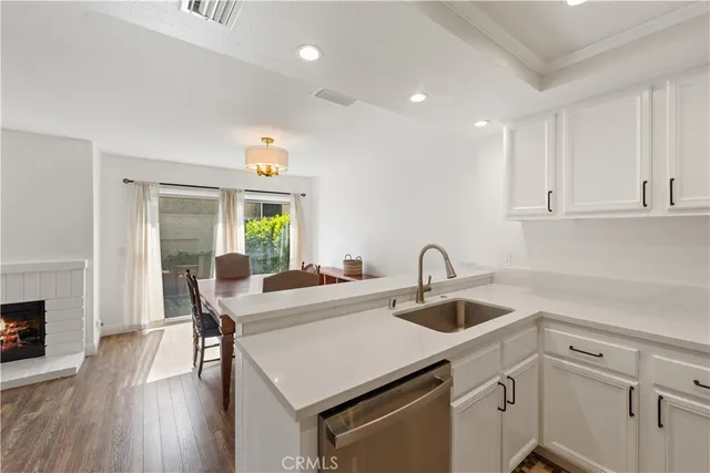 a kitchen with a table chairs and white cabinets