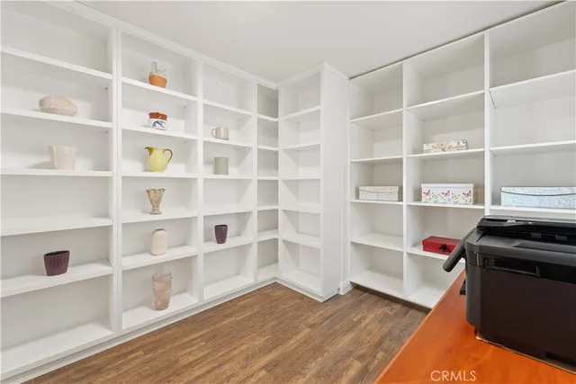 a room with a wooden floor and shelf