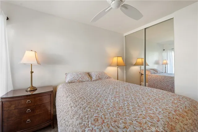 a bedroom with a bed and a lamp