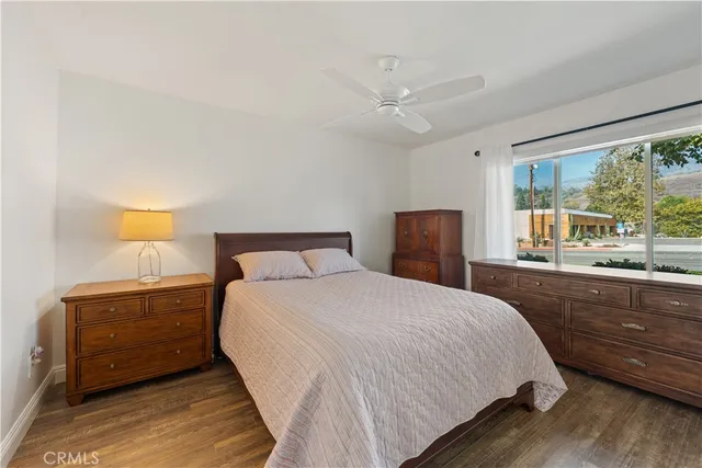 a bedroom with a bed and a large window