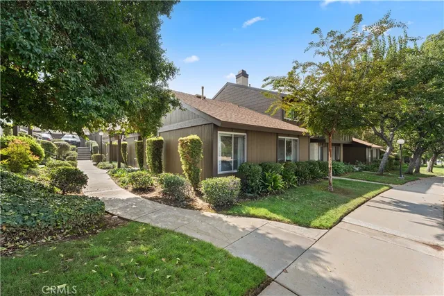 a front view of a house with a garden