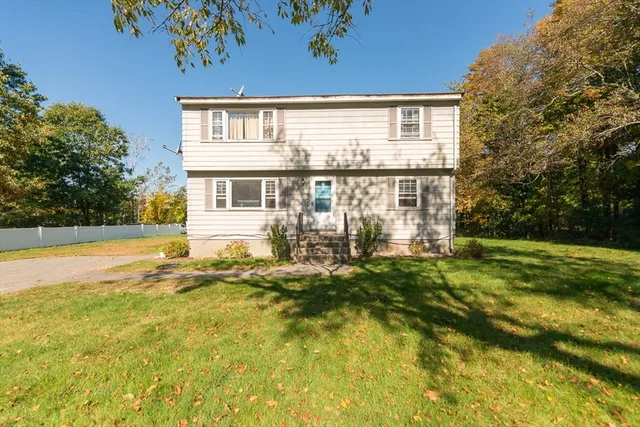 a view of a house with pool and sitting area