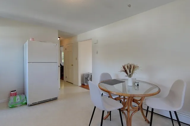 a kitchen with a refrigerator and table