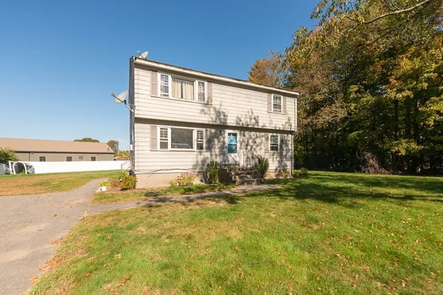 a view of a house with pool and sitting area