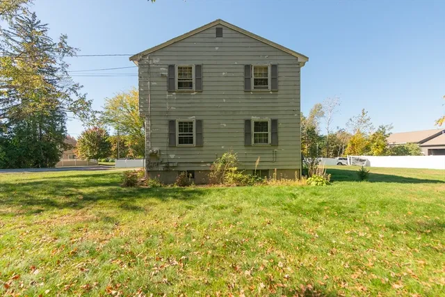 a front view of house with yard and trees