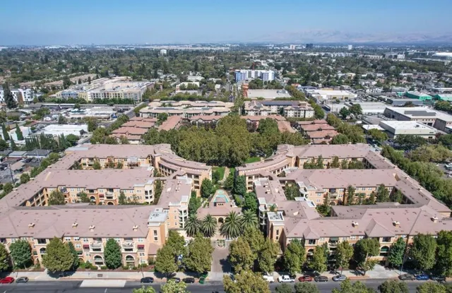 a view of a hallway with windows and a bathroom