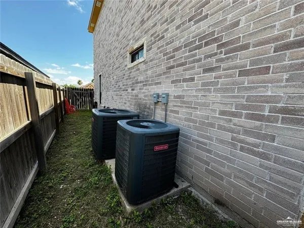 a view of a house with a yard and potted plants