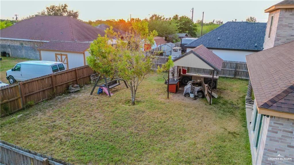 2117 Roman Street Mission, TX 78573 - Photo 15 of 17 a view of a house with a yard and potted plants