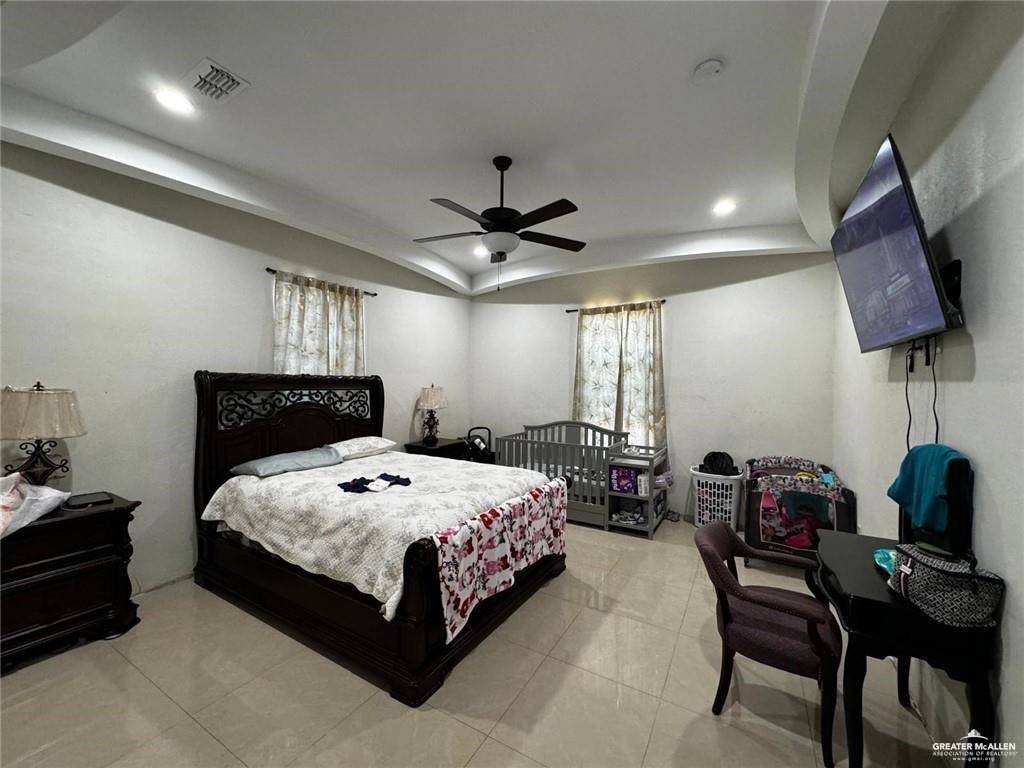 2117 Roman Street Mission, TX 78573 - Photo 7 of 17 a bedroom with a bed a couch and a chandelier