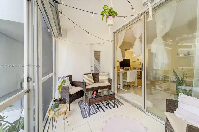 a view of a balcony with chairs and table in a patio