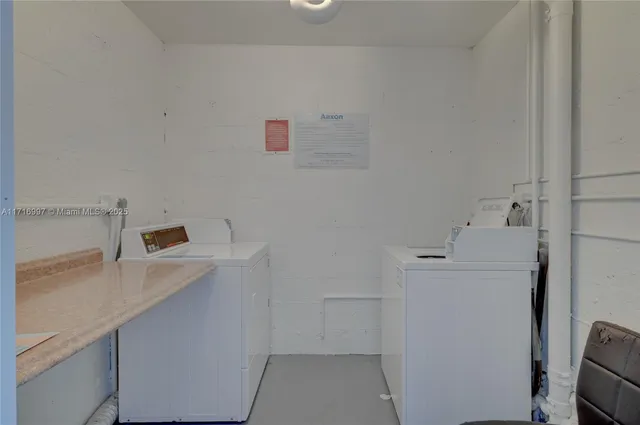 an aerial view of residential houses with outdoor space and a lake view