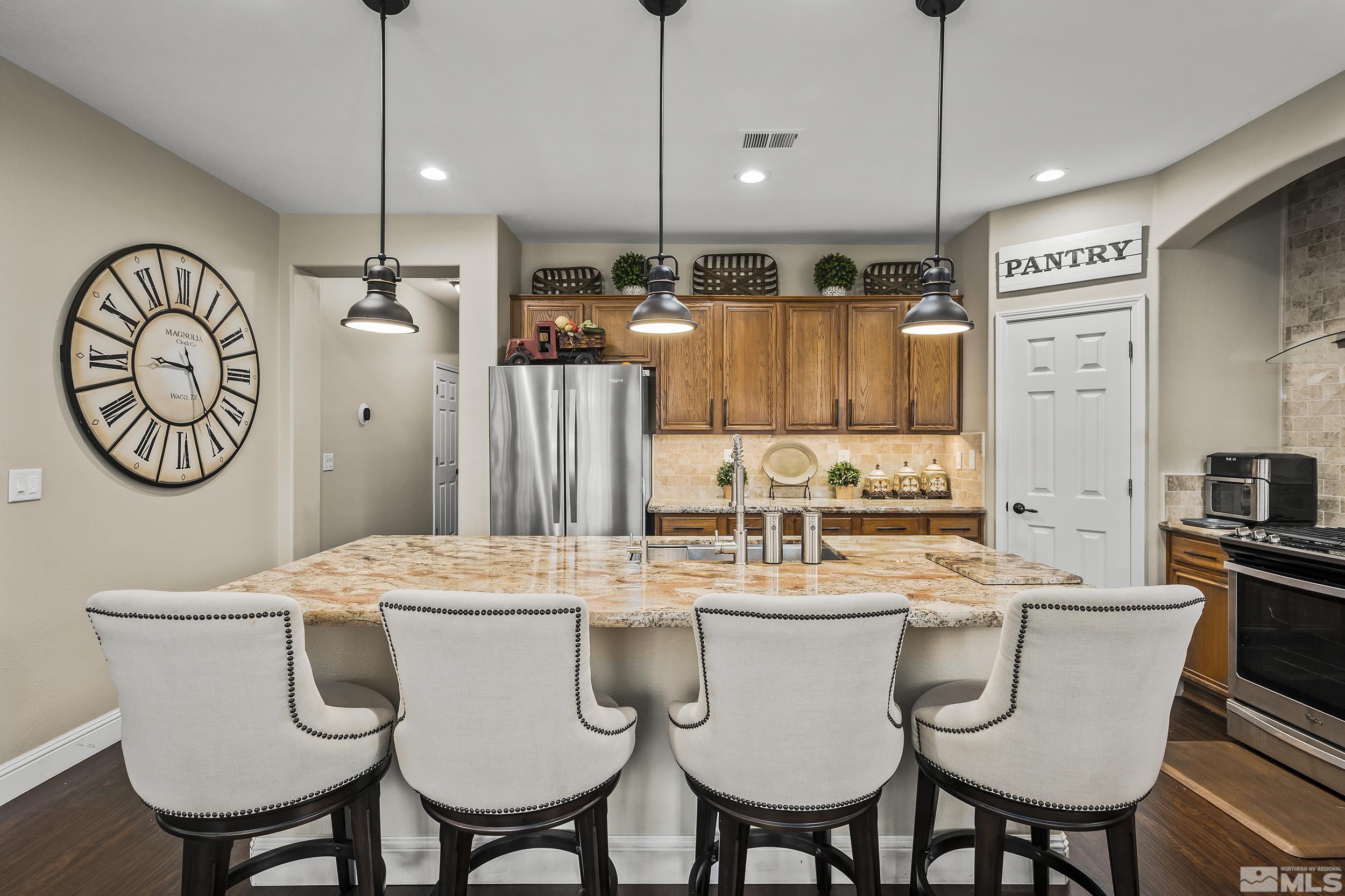 1484 Gaucho Lane Reno, NV 89521 - Photo 8 of 37 a dining table with chairs and kitchen view