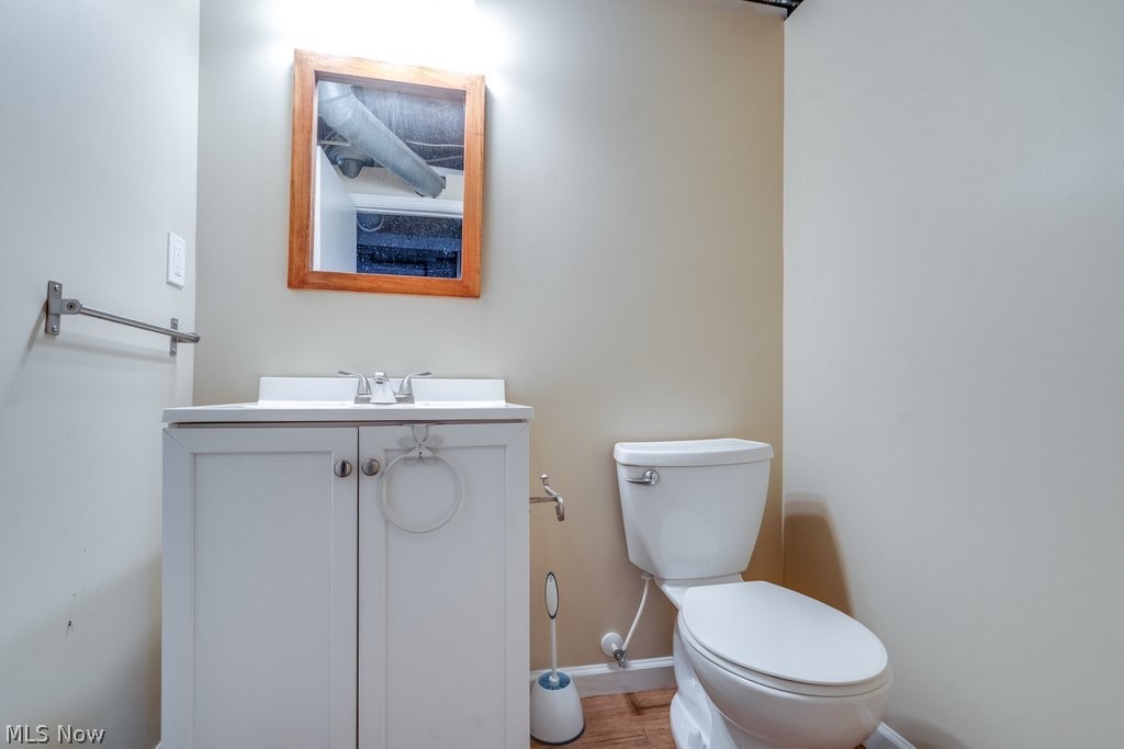 30000 Elgin Road Wickliffe, OH 44092 - Photo 24 of 30 Bathroom featuring a white vanity with built-in sink, wood-framed mirror, and a two-piece toilet