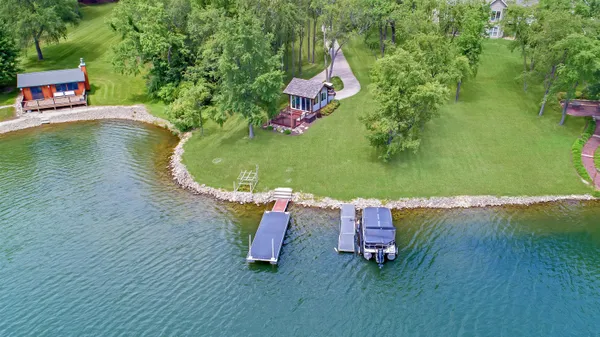 an aerial view of a house with a garden and swimming pool