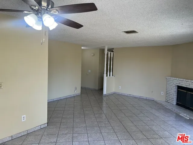 wooden floor in an empty room with a fireplace
