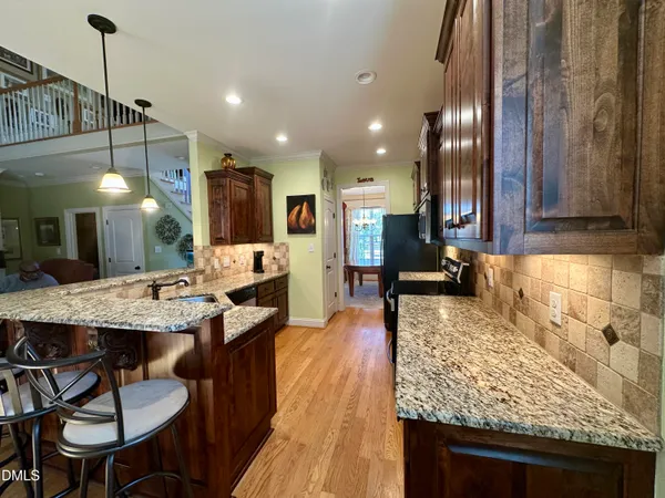 a large kitchen with a table and chairs
