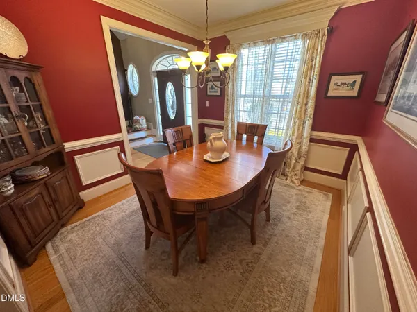 a view of a dining room with furniture and chandelier