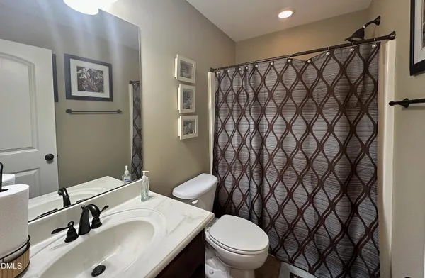 a bathroom with a sink toilet and a mirror