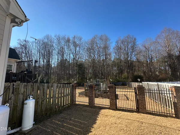 a view of a park with iron fence