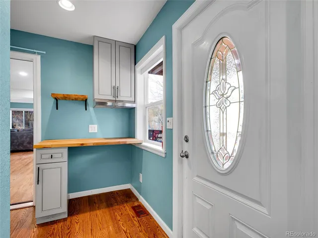 a view of a livingroom with wooden floor and a window