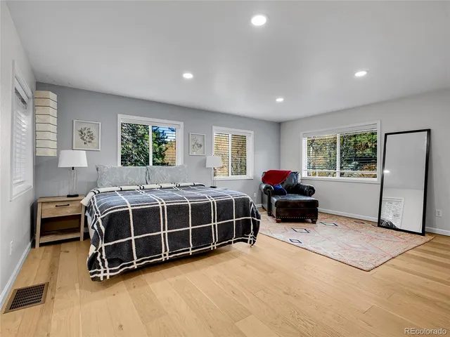 a spacious bedroom with a bed and a window