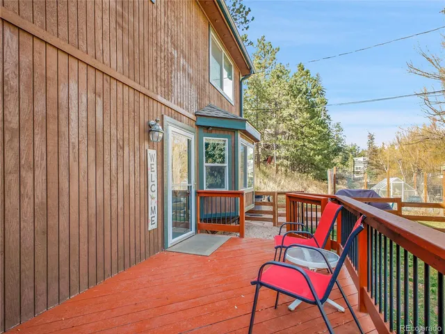 a outdoor view with a chairs and table in the balcony