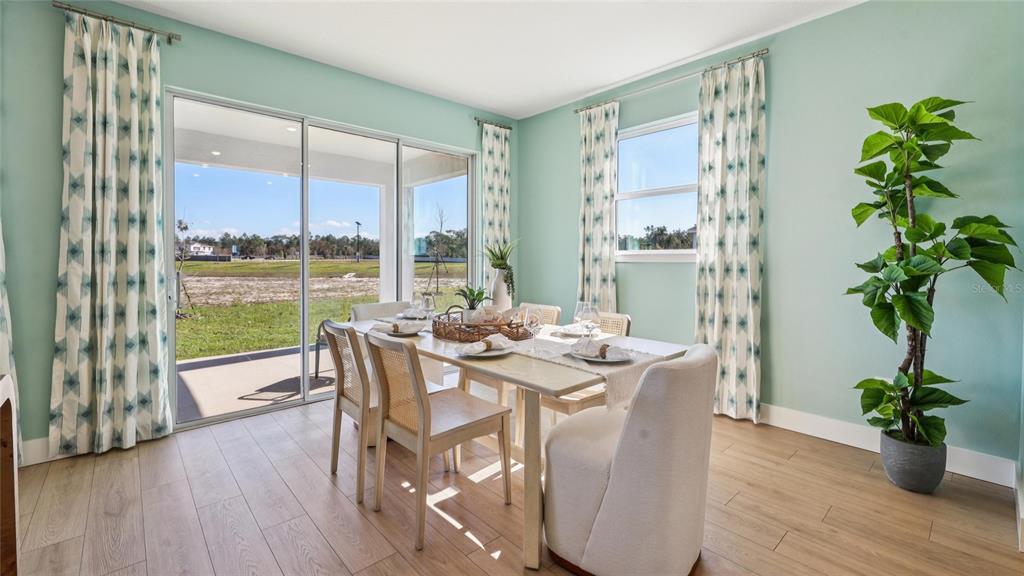 4216 Southwest 52nd Lane Road Ocala, FL 34474 - Photo 14 of 48 a view of a dining room with furniture window and wooden floor