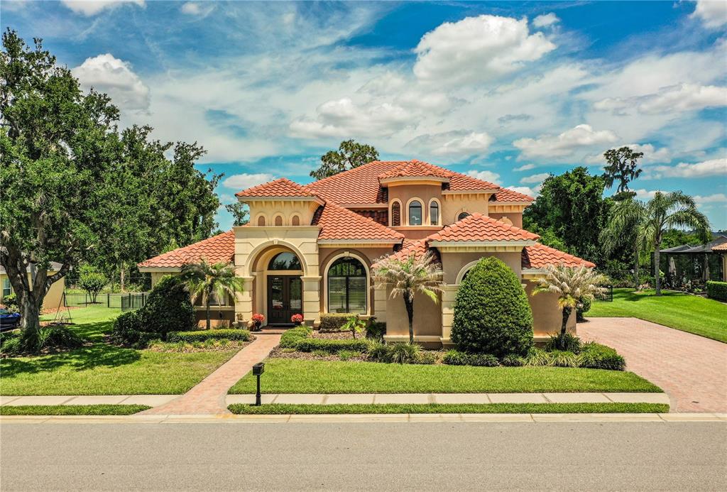 6739 Eagle Ridge Boulevard Lakeland, FL 33813 - Photo 1 of 54 a front view of a house with a yard