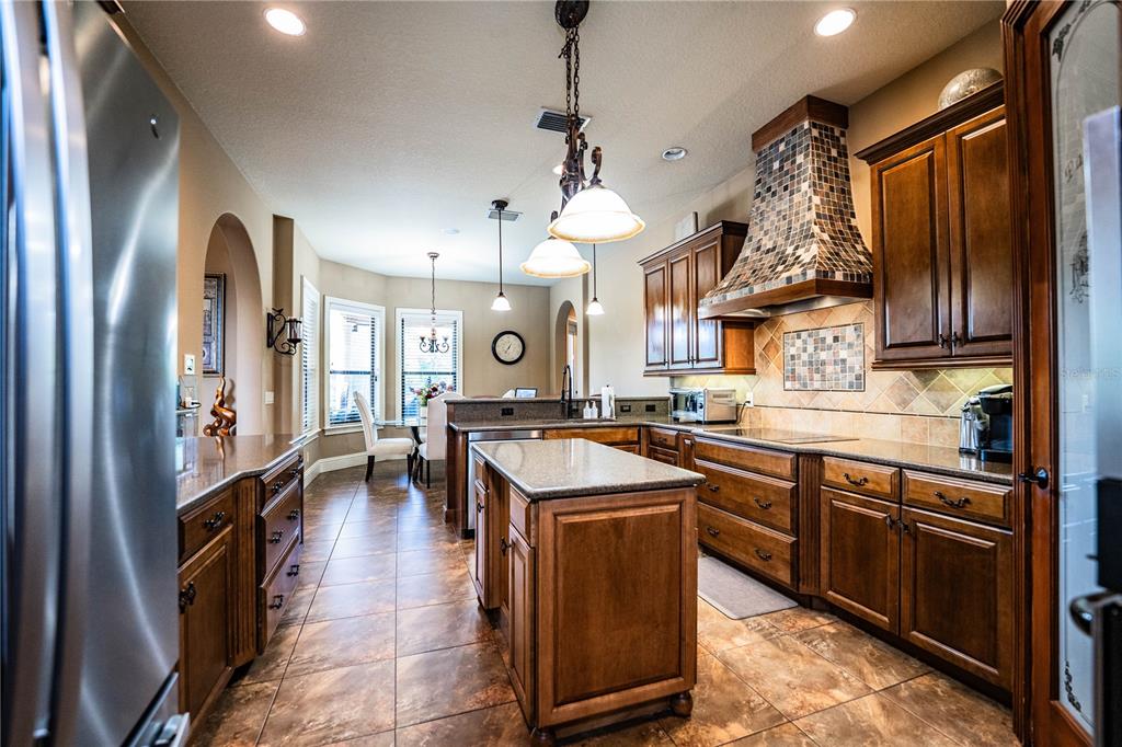 6739 Eagle Ridge Boulevard Lakeland, FL 33813 - Photo 22 of 54 a kitchen with stainless steel appliances granite countertop a sink a stove and a refrigerator