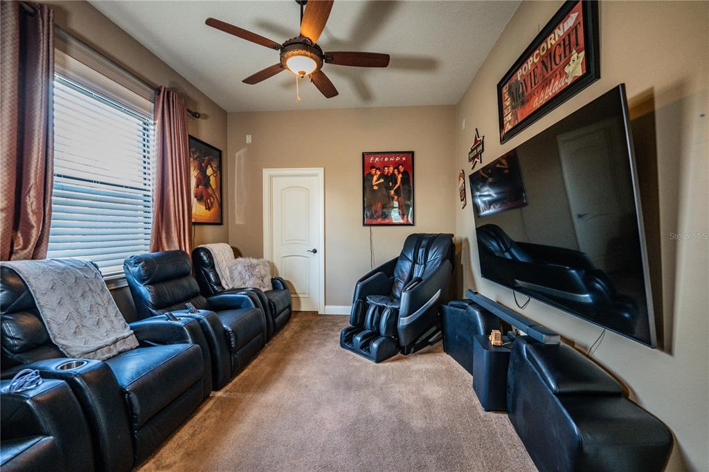 6739 Eagle Ridge Boulevard Lakeland, FL 33813 - Photo 26 of 54 a living room with furniture and a flat screen tv