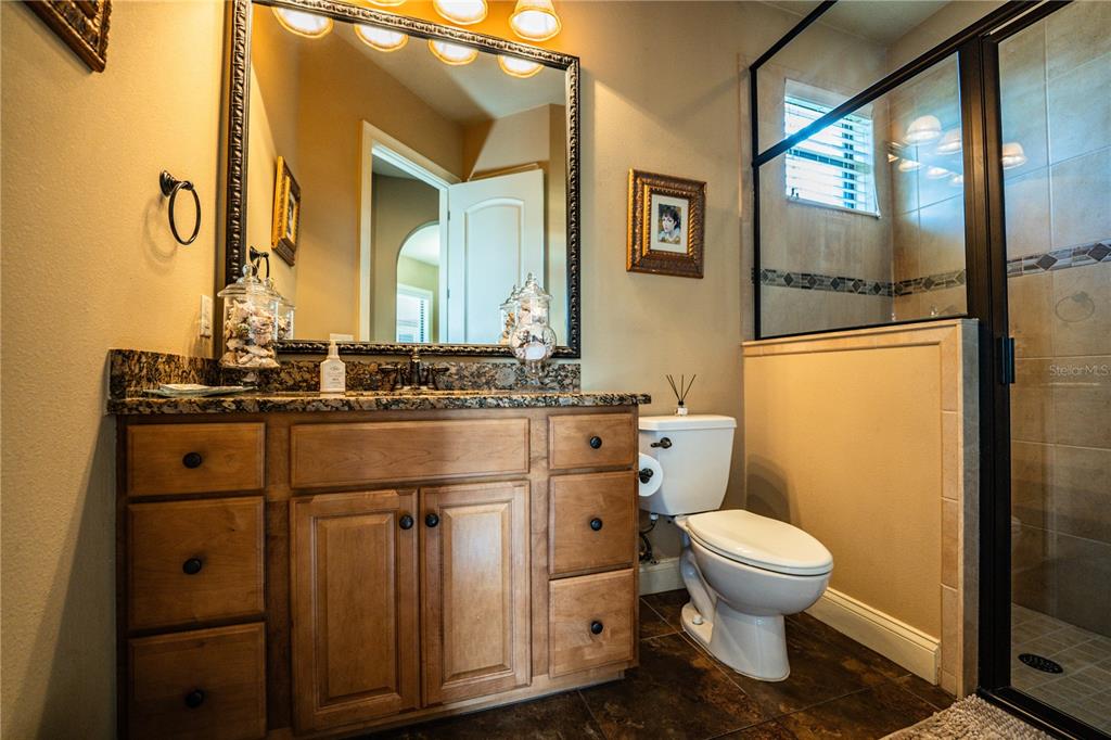 6739 Eagle Ridge Boulevard Lakeland, FL 33813 - Photo 27 of 54 a bathroom with a sink a toilet and mirror