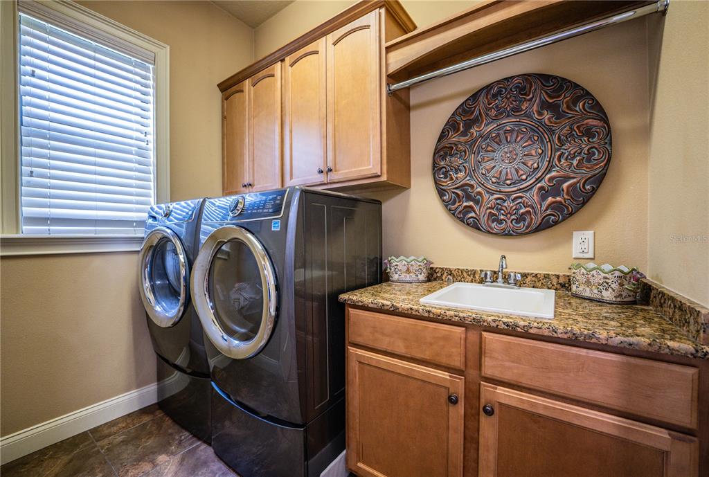 6739 Eagle Ridge Boulevard Lakeland, FL 33813 - Photo 29 of 54 a bathroom with a granite countertop sink and a mirror