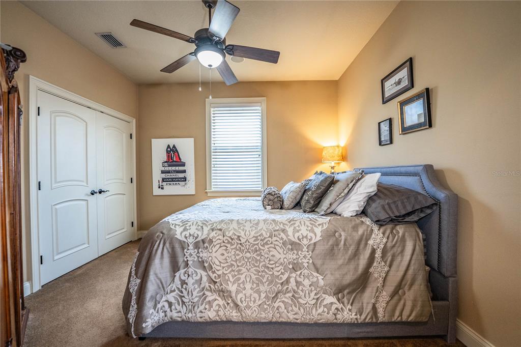 6739 Eagle Ridge Boulevard Lakeland, FL 33813 - Photo 32 of 54 a bedroom with a bed and a dresser
