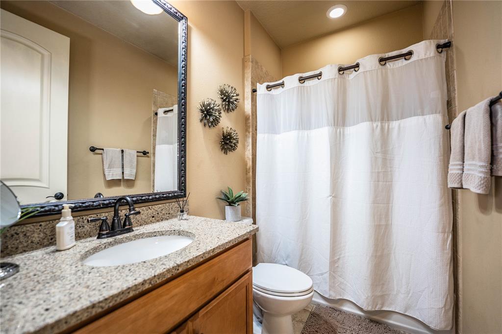 6739 Eagle Ridge Boulevard Lakeland, FL 33813 - Photo 33 of 54 a bathroom with a granite countertop sink toilet and shower
