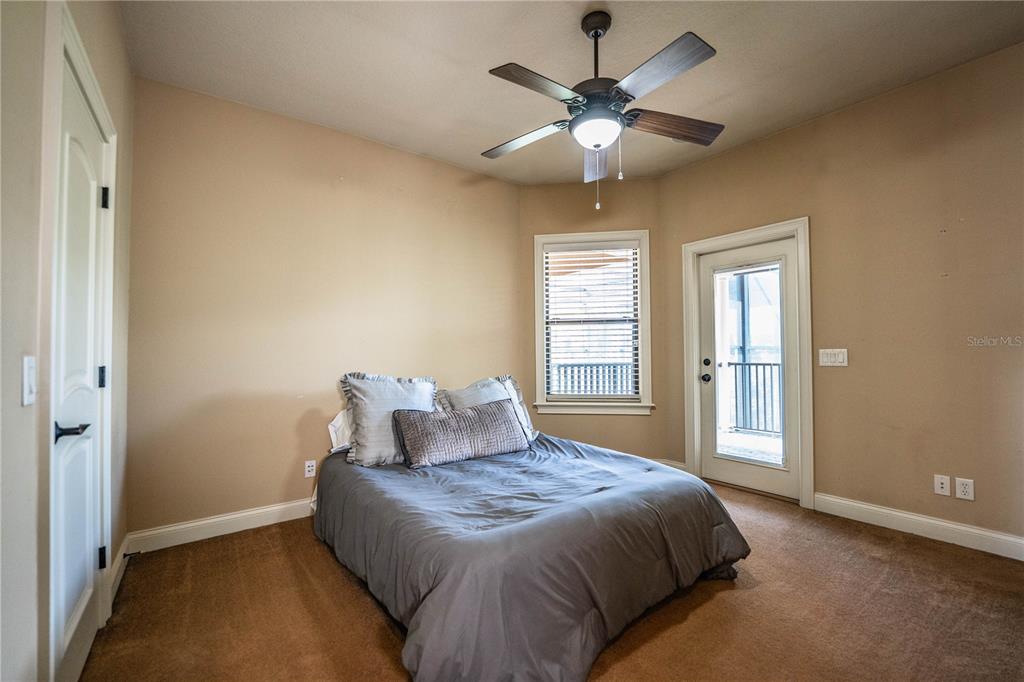 6739 Eagle Ridge Boulevard Lakeland, FL 33813 - Photo 34 of 54 a bedroom with a large bed and a chandelier