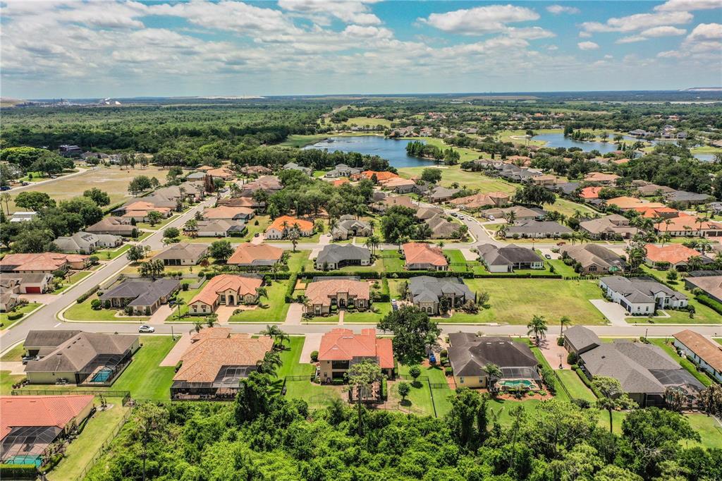 6739 Eagle Ridge Boulevard Lakeland, FL 33813 - Photo 46 of 54 an aerial view of residential houses with outdoor space and trees
