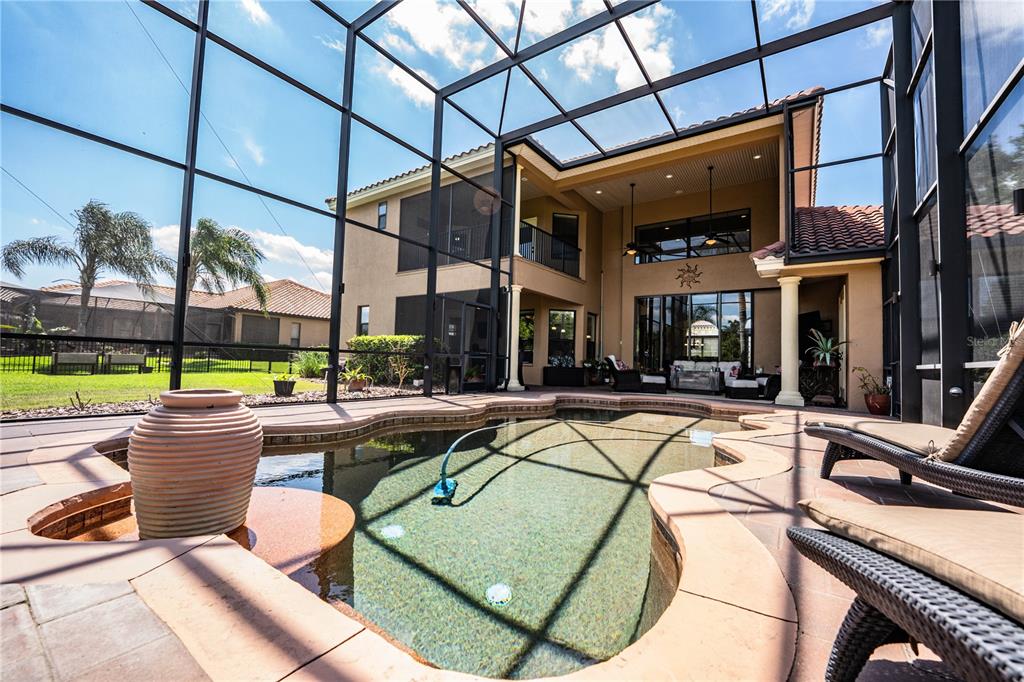 6739 Eagle Ridge Boulevard Lakeland, FL 33813 - Photo 50 of 54 a view of a patio with a dining table chairs and iron fence