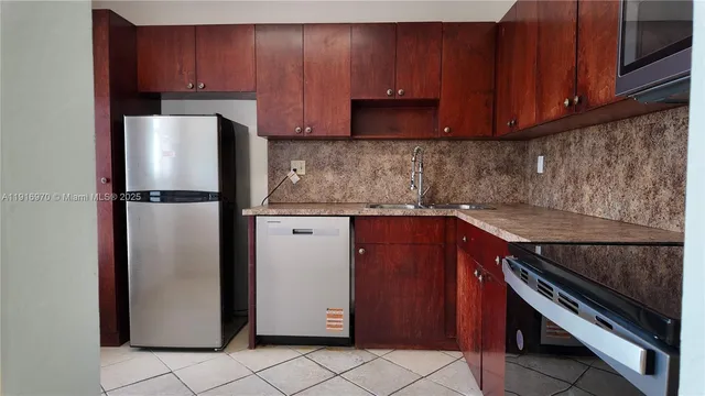 a kitchen with a refrigerator and a cabinets