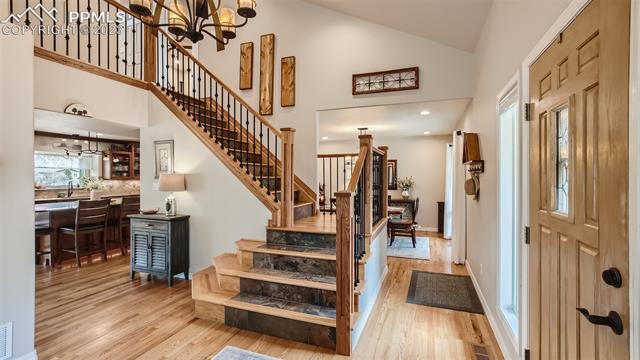 4710 Sandstone Road Monument, CO 80132 - Photo 13 of 28 Newly built custom staircase and entry with view to the formal dining room and kitchen. Be sure to check out the virtual tour link for more...