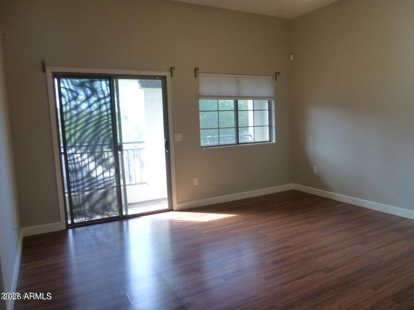 2727 North Price Road, Unit 28 Chandler, AZ 85224 - Photo 1 of 14 an empty room with wooden floor and windows