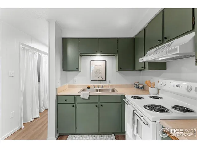 a kitchen with a sink a stove and cabinets