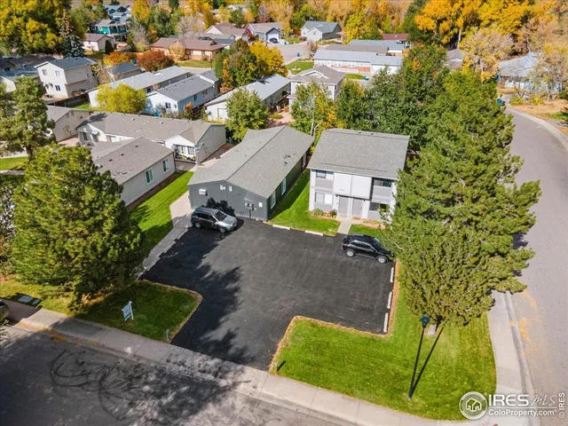 an aerial view of a house with a yard and trees