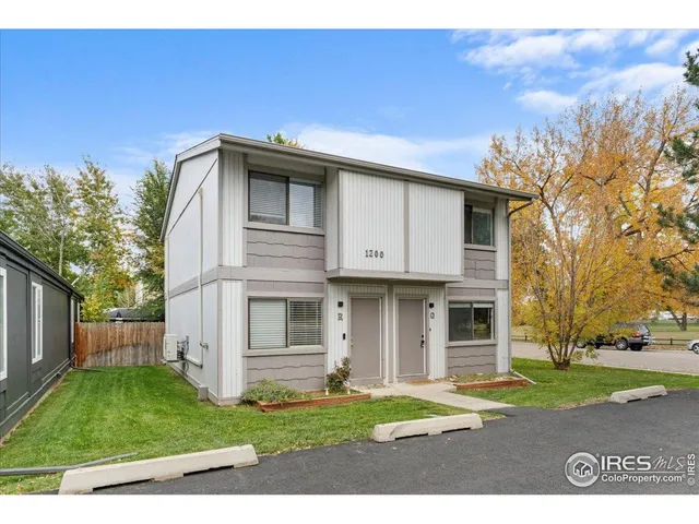 a view of backyard with potted plants and wooden fence