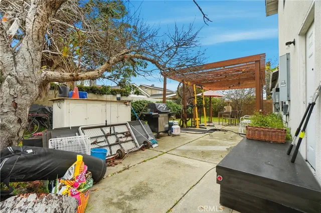 a view of a backyard with table and chairs under an umbrella